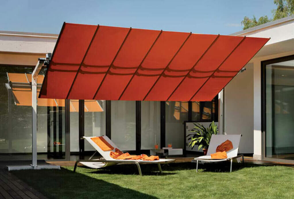 Red freestanding awning over a backyard area