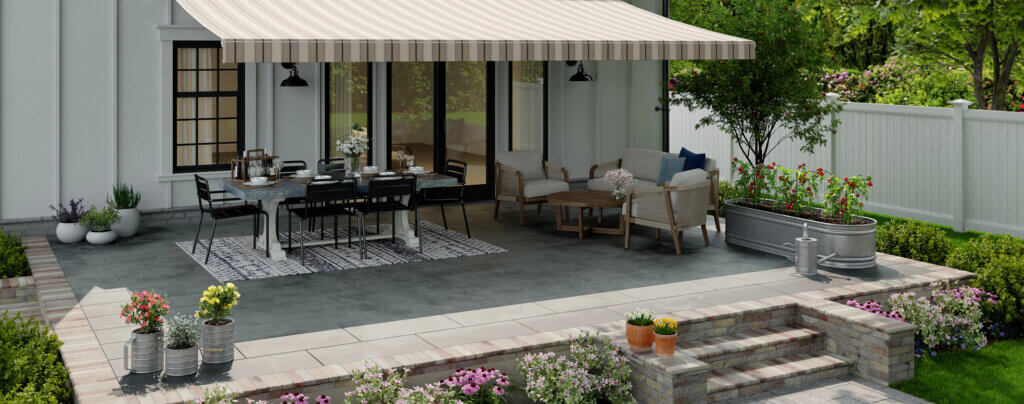 Large sunsetter patio awning over eating area and relaxing furniture