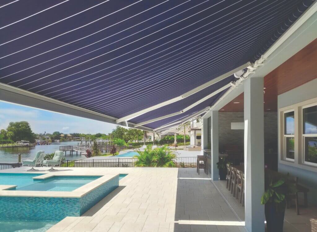 Large steep summerspace brand awning over deck with pool