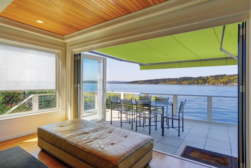 Summerspace brand awning over deck on the edge of a beautiful mountain lake