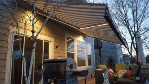 A Colorado Retractable Awning with Lights installed over a deck